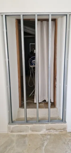 Metal stud framework installed to close the original opening