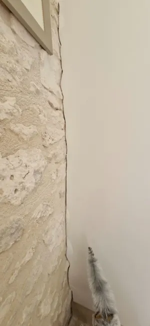 Detail where the new wall finish meets the original stonework