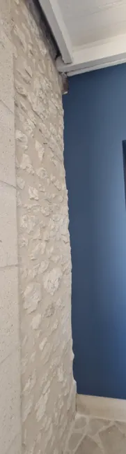 Finished junction between the traditional stone and deep-blue wall