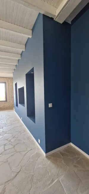 Deep-blue wall viewed from the opposite end of the room