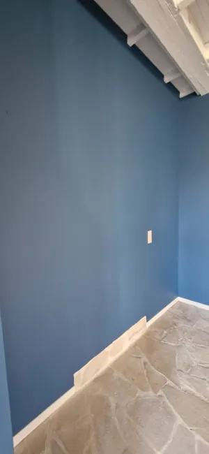 Finished blue interior with clean edges and white ceiling beams